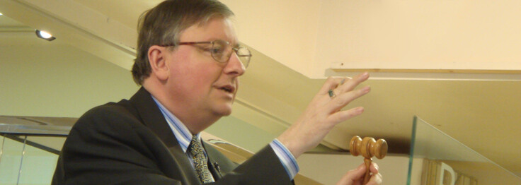 John Sandon with an auctioneer’s gavel